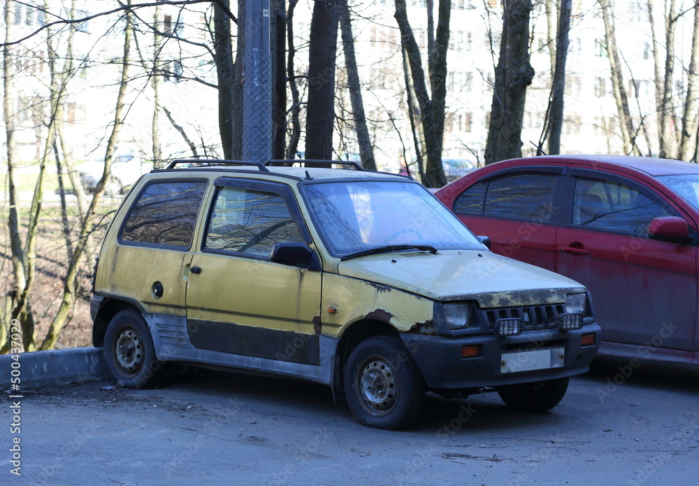 An old rusty Soviet minicar is parked on the street, Podvoysky Street, St. Petersburg, Russia, April 2022 An old rusty Soviet minicar is parked on the street, Podvoysky Street, St. Petersburg, Russia, April 2022