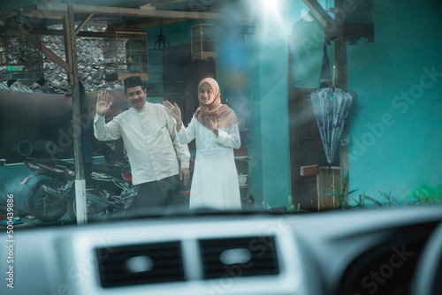 Tableau sur toile asian family coming home to their parent's house by car during idul fitri celebr