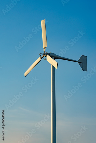 Windmill with blue sky for evironment clean power concept photo