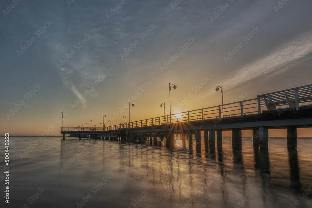 Sunset over a wooden pier in Jurata, Baltic Sea, Poland. 