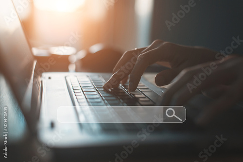  People hand using laptop or computor searching for information in internet online society web with search box icon and copyspace.