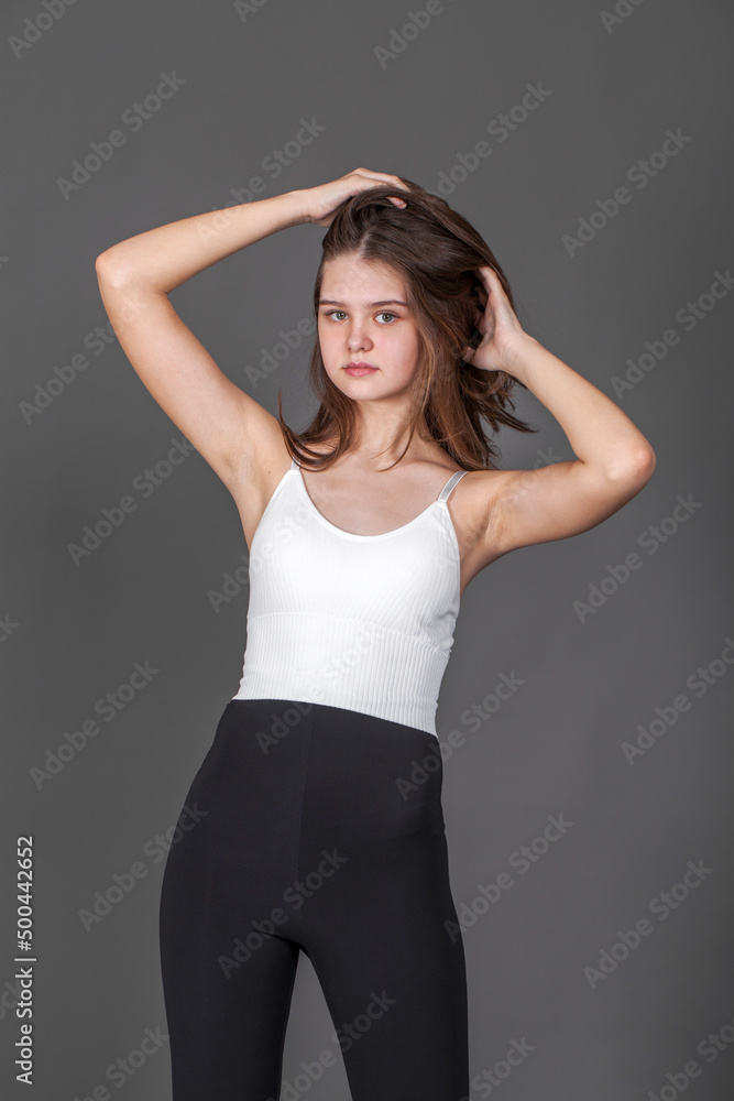 Portrait of a young brunette woman, isolated on gray background Portrait of a young brunette woman, isolated on gray background