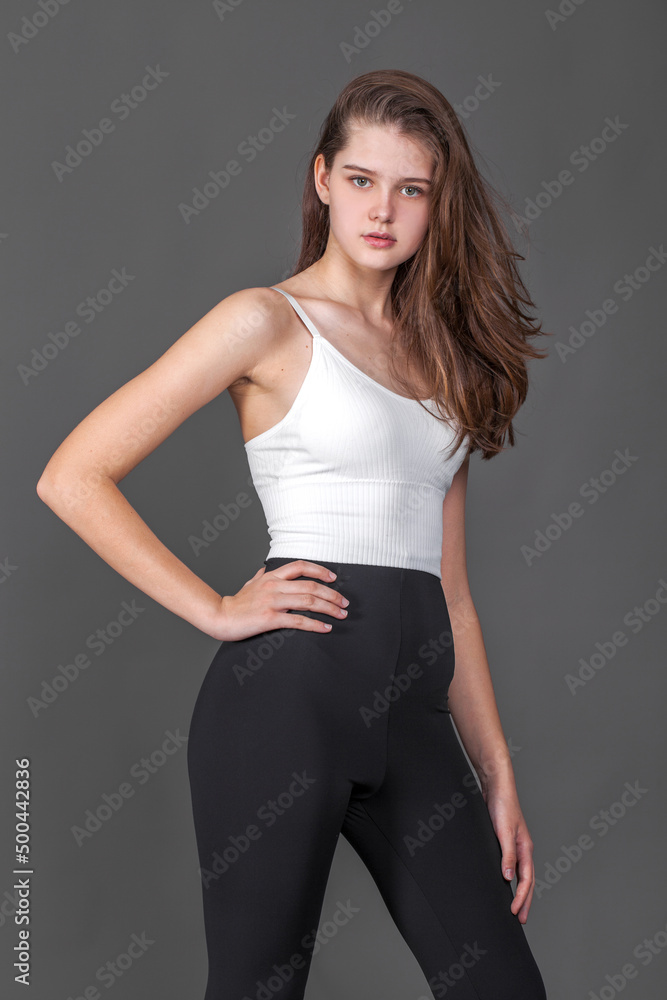 Portrait of a young brunette woman, isolated on gray background Portrait of a young brunette woman, isolated on gray background