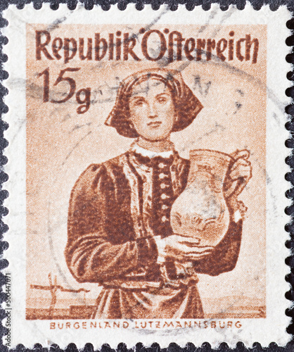 Austria - circa 1948: a postage stamp from Austria, showing a woman with traditional provincial costume. Burgenland, Lutzmannsburg