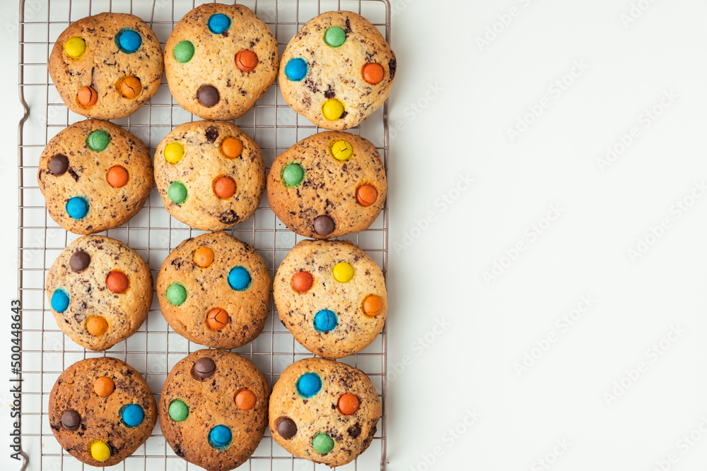 Shortbread cookies with multi-colored chocolate droplets on the white background