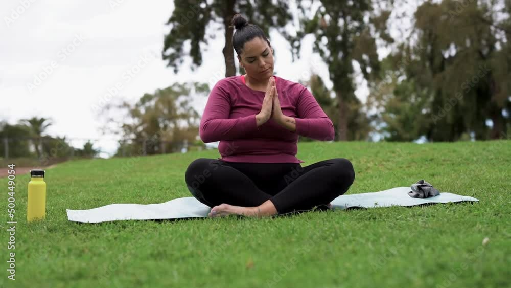 Curvy woman doing yoga exercise at city park - Healthy lifestyle and sport concept Curvy woman doing yoga exercise at city park - Healthy lifestyle and sport concept