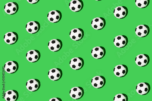 Seamless pattern made of football, soccer ball isolated on green background. Isometric view. Sport concept.