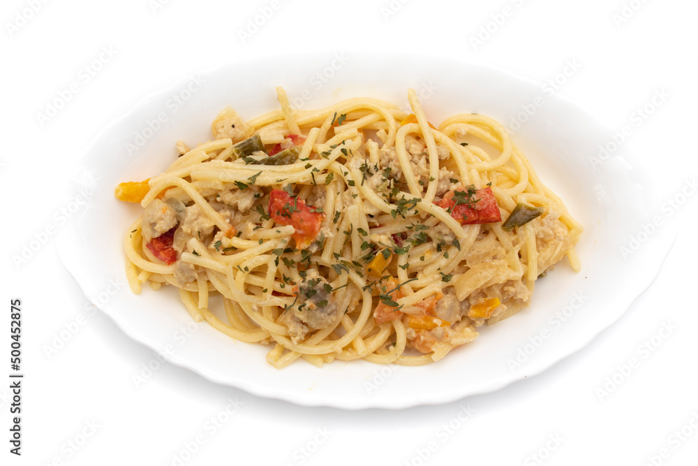 Spaghetti carbonara on a long white plate, isolated on white background. Carbonara is an Italian pasta dish originating from Lazio, and more specifically from Rome.