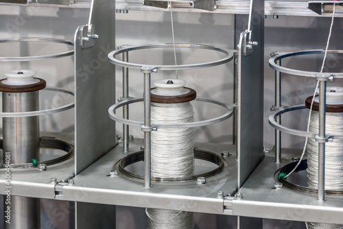 bobbins with rope on the machine of a clothing factory photo