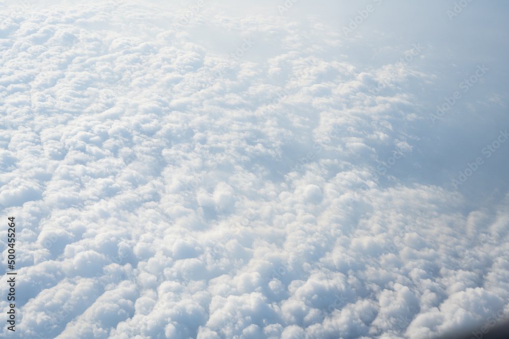 Top view fluffy clouds look in the airplane.Blue sky and white clouds background.Free space. Fresh day and the weather is bright. Heavenly landscape. Top view fluffy clouds look in the airplane.Blue sky and white clouds background.Free space. Fresh day and the weather is bright. Heavenly landscape.