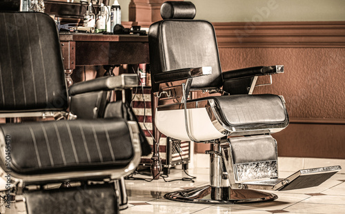 Stylish vintage barber chair. Professional hairstylist in barbershop interior. Barber shop chair. Barbershop armchair, modern hairdresser and hair salon, barber shop for men. Beard, bearded man
