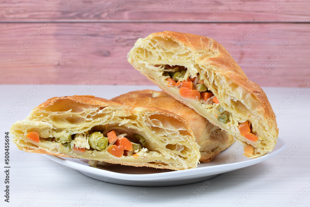 Fototapeta premium Puff pastry cake with vegetables and cheese, on wooden background