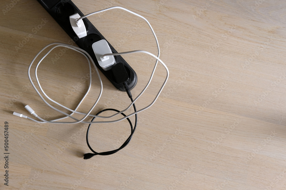 mobile usb chargers with tangled wires on floor mobile usb chargers with tangled wires on floor