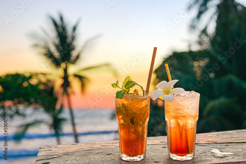 Fototapeta Naklejka Na Ścianę i Meble -  drinks with blur beach and sunset in background