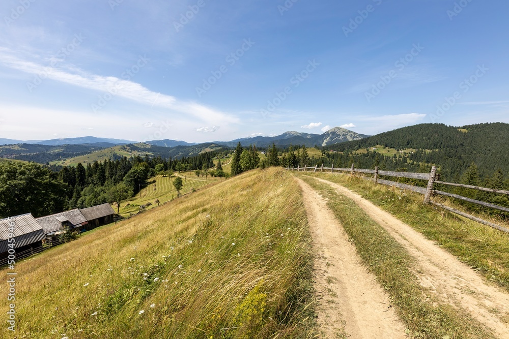Mountain dirt road in the Ukrainian Carpathians on a summer day. Mountain dirt road in the Ukrainian Carpathians on a summer day.