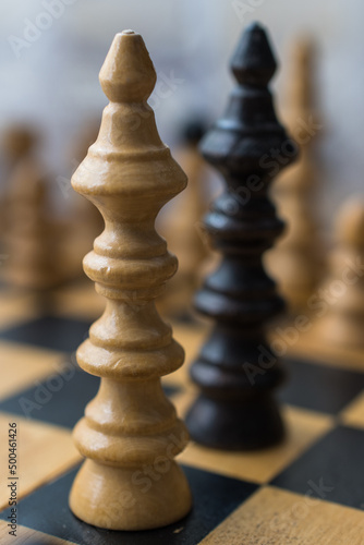 Chess board with figures. The concept of negotiation, the main figures in focus.