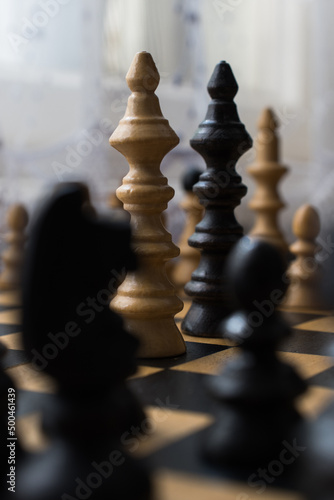 Chess board with figures. The concept of negotiation, the main figures in focus.