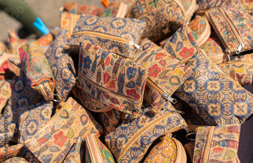 Cork wallets Portuguese souvenirs, brown cork bags, at the street market in Porto, Portugal.