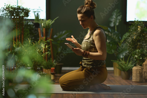sad modern woman doing yoga at modern green home