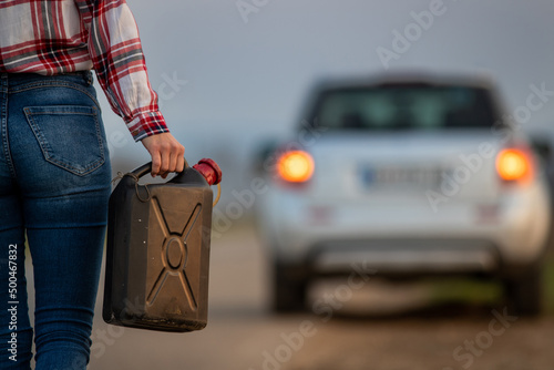 Close up of a woman holding fuel canister. photo