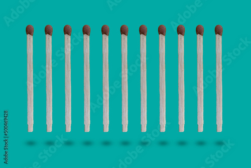 row of the wooden matches in the air on colorful background