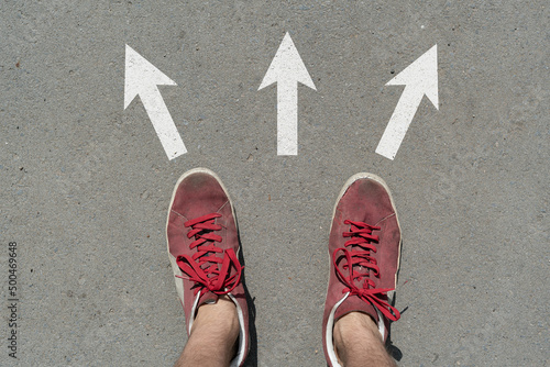 Cuadro en lienzo difficult to choose where to go, feet stand on the asphalt abstract surface arro