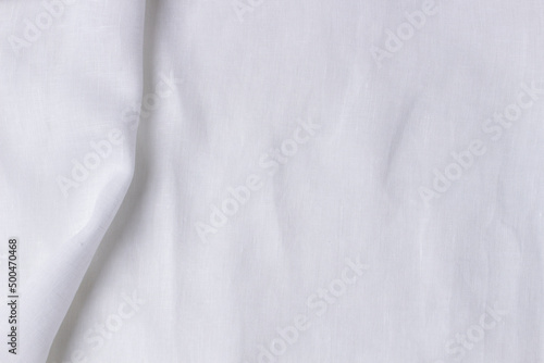 White crumpled linen fabric texture background. Natural linen organic eco textiles canvas background. Top view