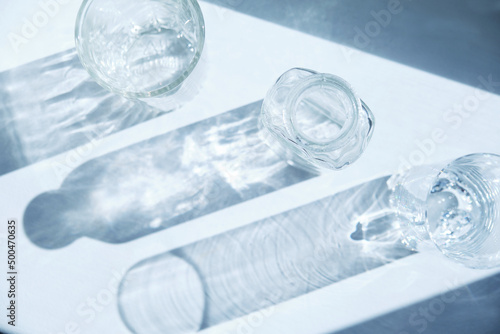 Bohemian crystal glass sharp. Still life scene with glasses on beige background in sunlight. Minimal luxury background. photo