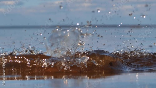 The stone is thrown into the water. Stonhe falls into the pond, visible circles on the water.