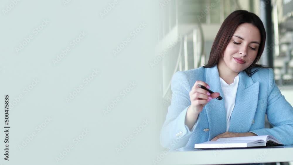 Business woman working in office and writing in notebook Business woman working in office and writing in notebook