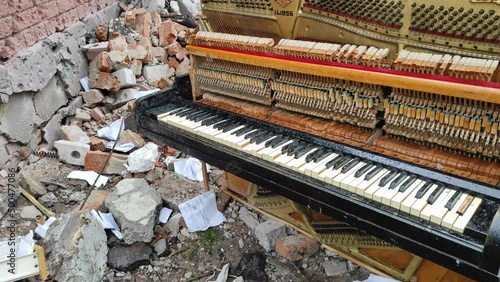 Chernihiv, Ukraine - April 17, 2022: Russia's war against Ukraine. Destroyed piano and thrown out by the blast from an apartment building after an airstrike. photo
