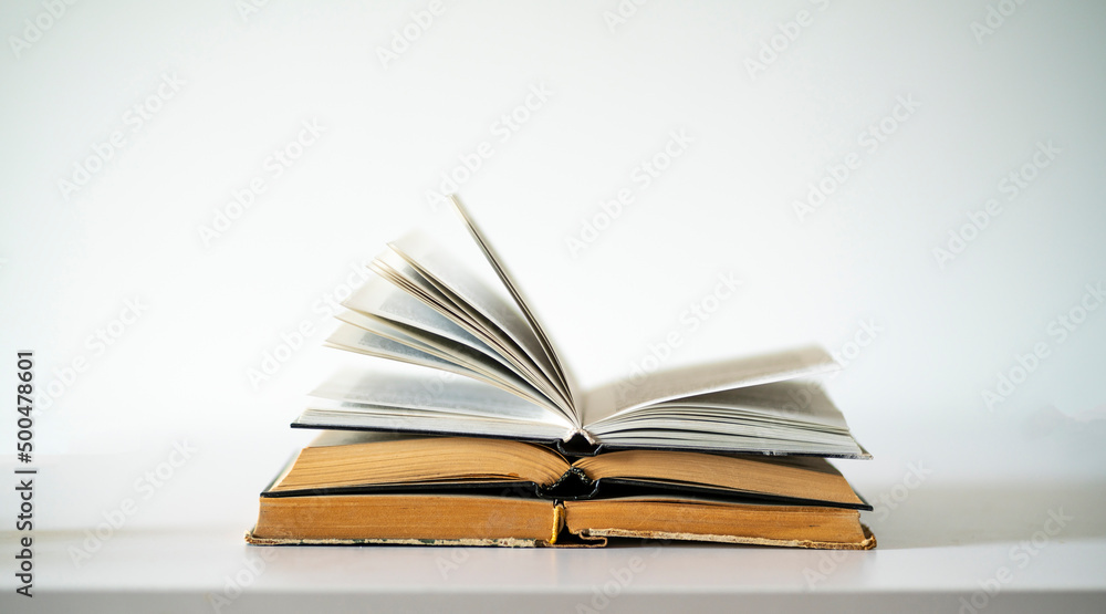 opened old book on the table as the symbol of wisdom and knowledge, education concept opened old book on the table as the symbol of wisdom and knowledge, education concept