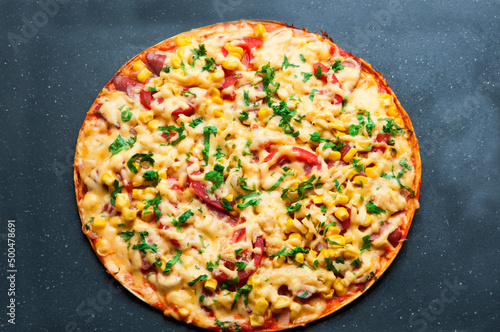 delicious pizza close up. carbonara with fresh vegetables. large pie with vegetable filling. fast food concept