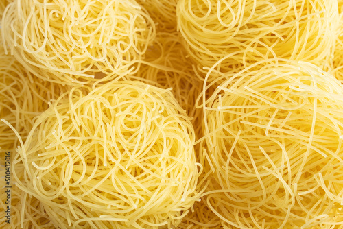 Obraz na plátně Texture of stacked vermicelli nests, still raw