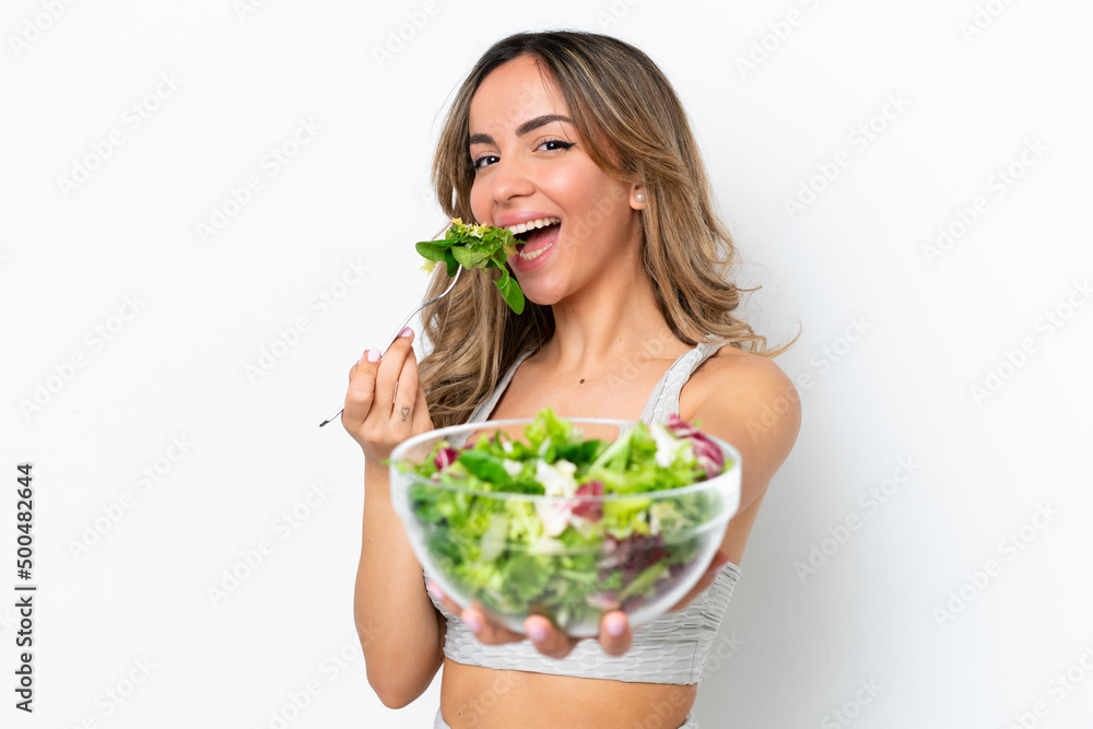 Young caucasian woman isolated on white background holding a bowl of salad with happy expression Young caucasian woman isolated on white background holding a bowl of salad with happy expression