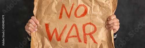 Child holding a banner with the inscription No war. Close-up. No war, stop the war, peace