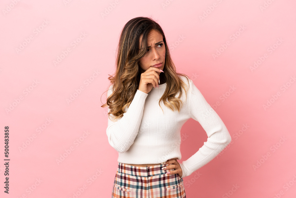 Young woman over isolated background having doubts and with confuse face expression Young woman over isolated background having doubts and with confuse face expression