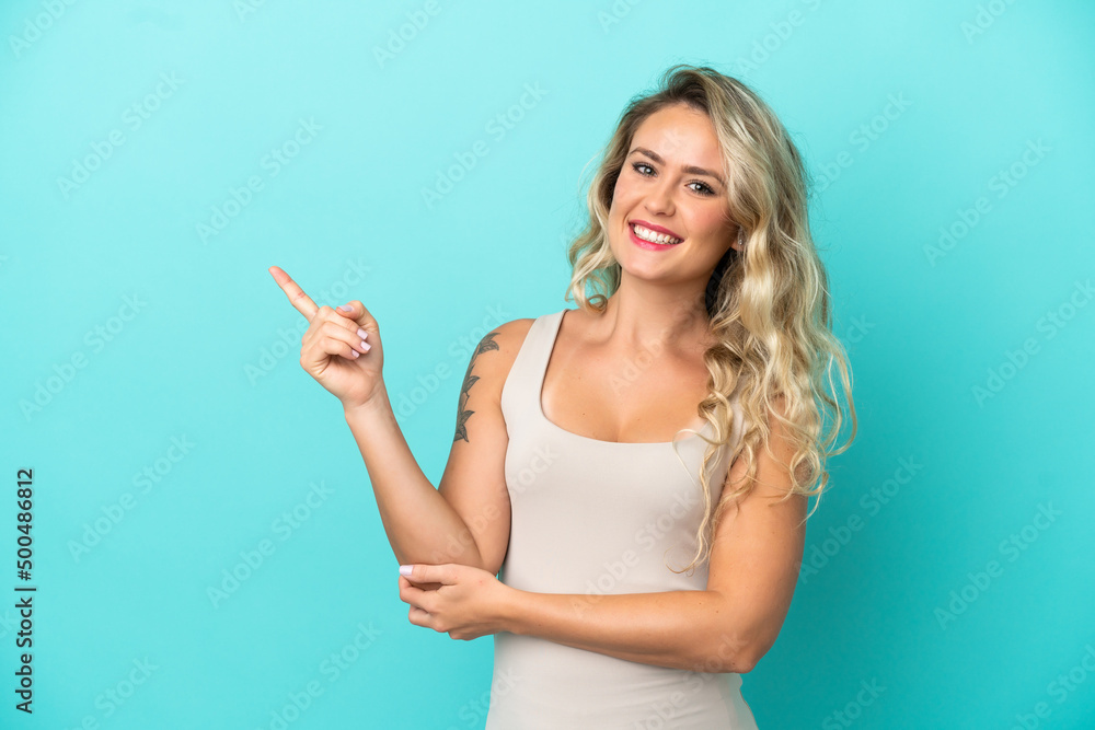 Young Brazilian woman isolated on blue background pointing finger to the side Young Brazilian woman isolated on blue background pointing finger to the side