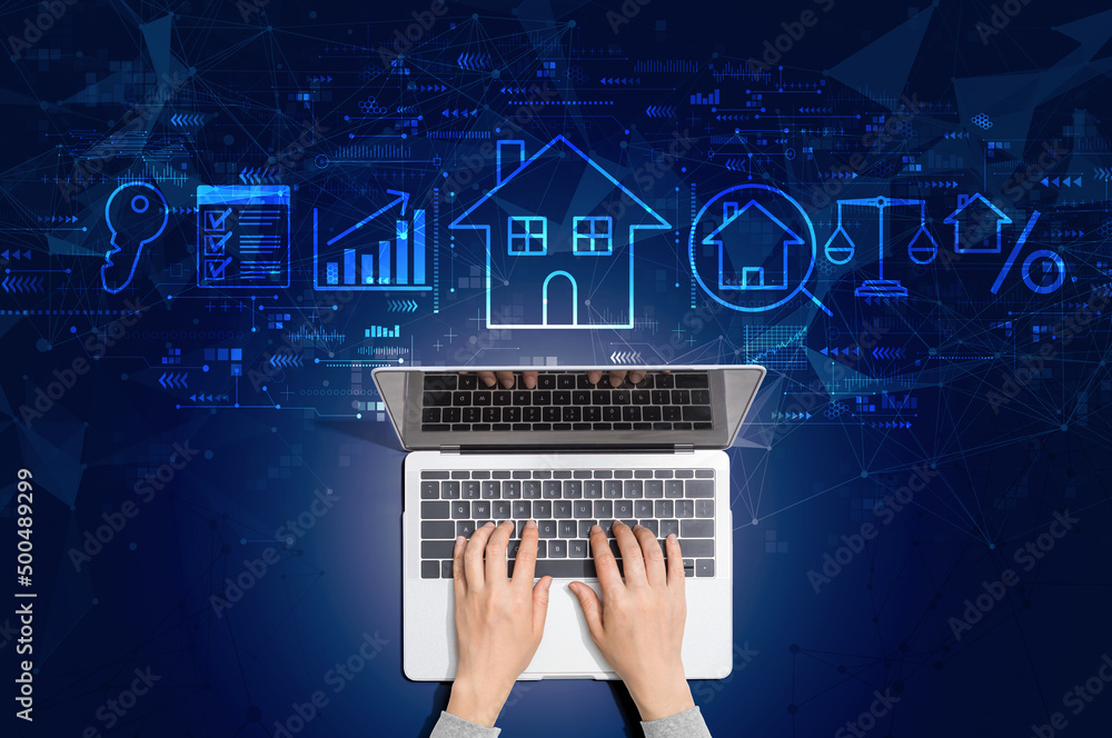 Real estate theme with person using a laptop computer - obrazy, fototapety, plakaty 