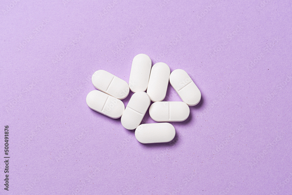 Several white medicine pills on a table. Several white medicine pills on a table.