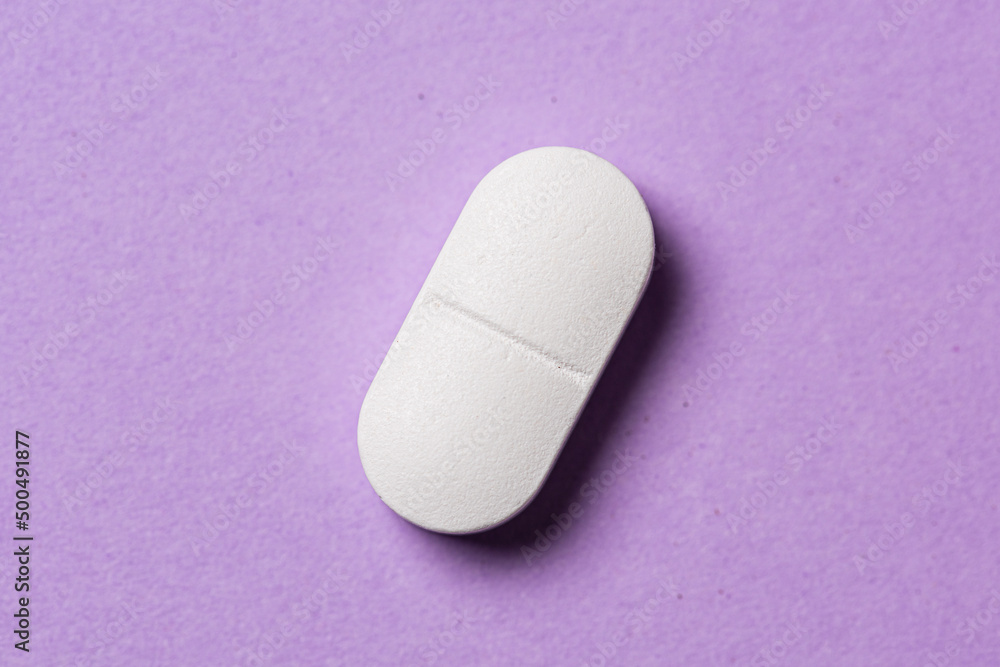 White medicine pill on a table. White medicine pill on a table.