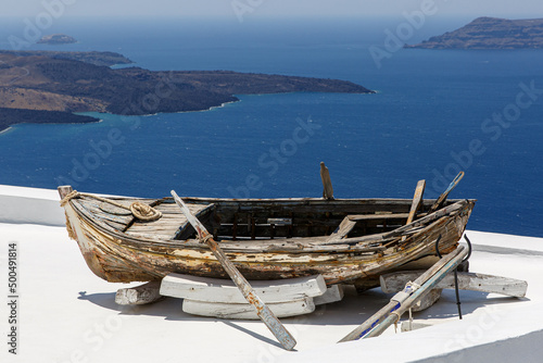Historical boat on top of the roofs at Santorini island, Greece.