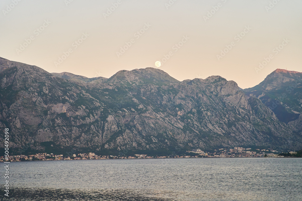 View of the sunset in Boko-Kotor Bay in Montenegro. Silhouettes of mountains. High quality photo