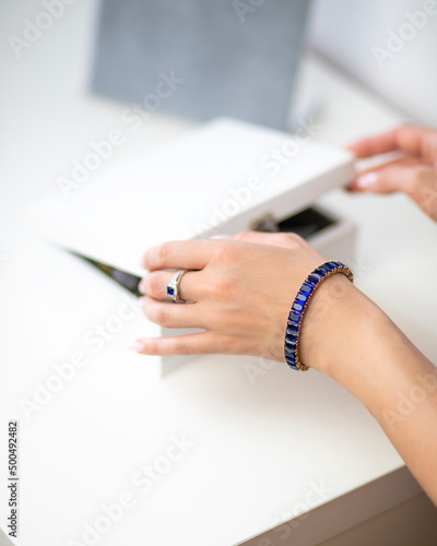 close up of a female hand holding a pen on a notebook