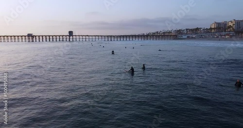 Surfers Riding Waves at Sunset