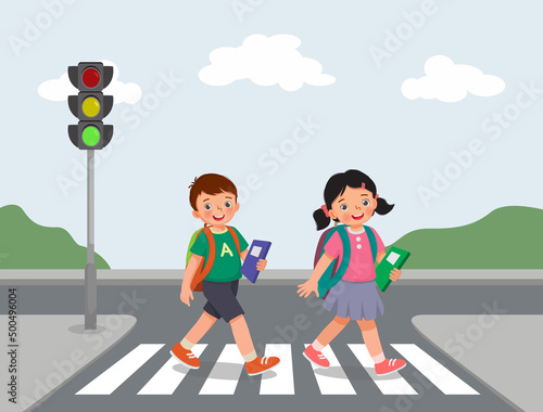 Cute School kids with backpack walking crossing road near traffic light on zebra crossing on the way to school