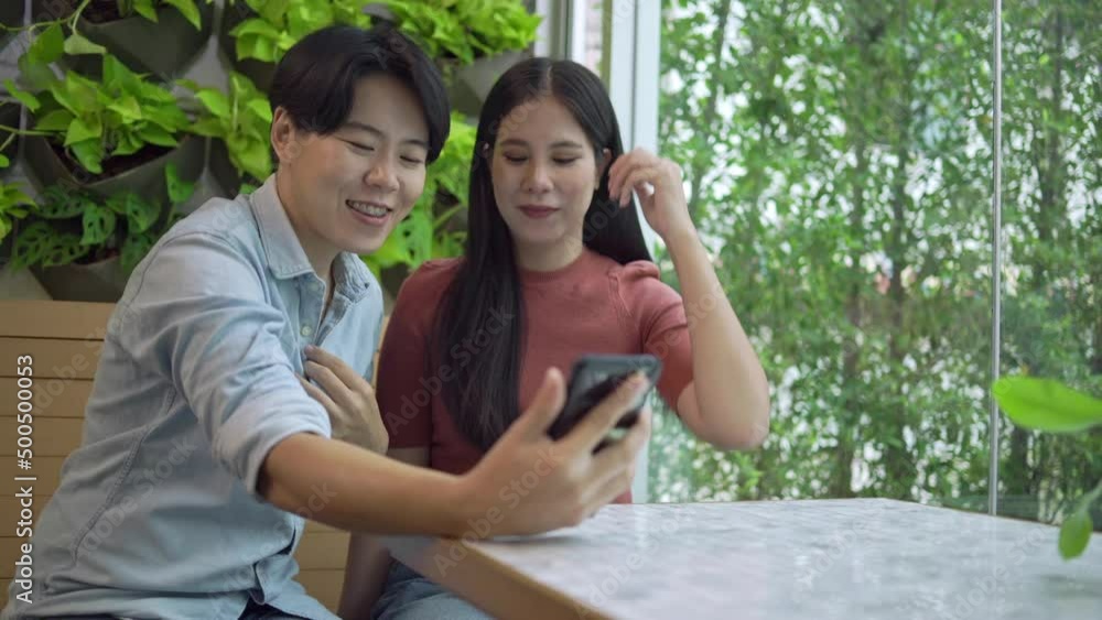 Women, LGBT couples dating at cafes They're drinking coffee. Talk and take selfies together in a happy and fun mood. in LGBT couples concept. Women, LGBT couples dating at cafes They're drinking coffee. Talk and take selfies together in a happy and fun mood. in LGBT couples concept.