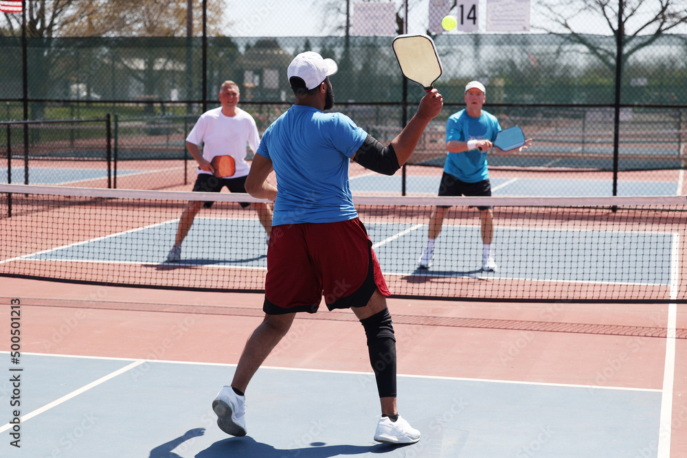 A pickleball smash during a men's game A pickleball smash during a men's game