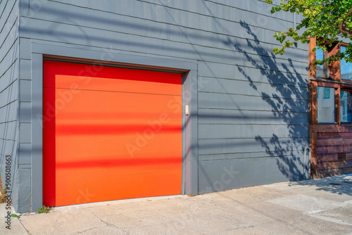 Fototapeta Naklejka Na Ścianę i Meble -  Garage exterior with orange canopy door at San Francisco, California