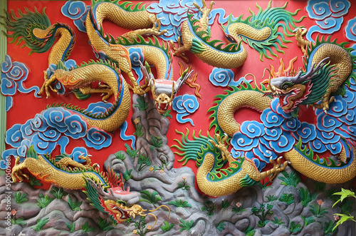 Closeup of Tha Colorful Dragon Decoration On the black wall background at Thai Temple at Thailand.